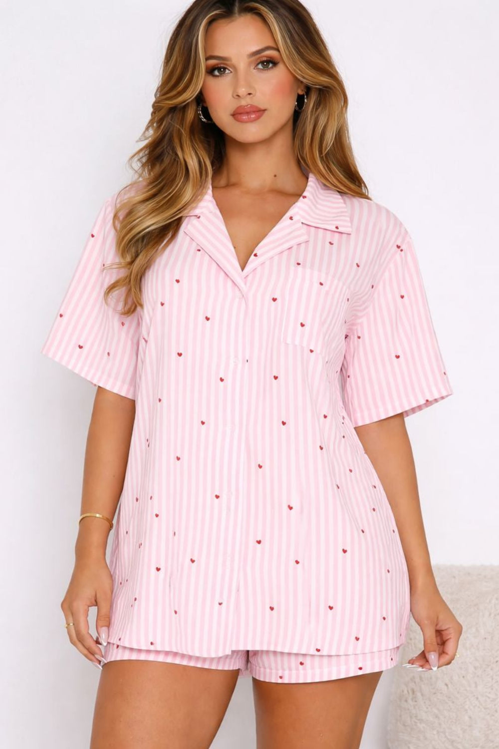 two-piece pajama set, striped with hearts, collared neck, short sleeve, front pocket, button down, shorts, elastic waist, bow tie, some stretch, front view