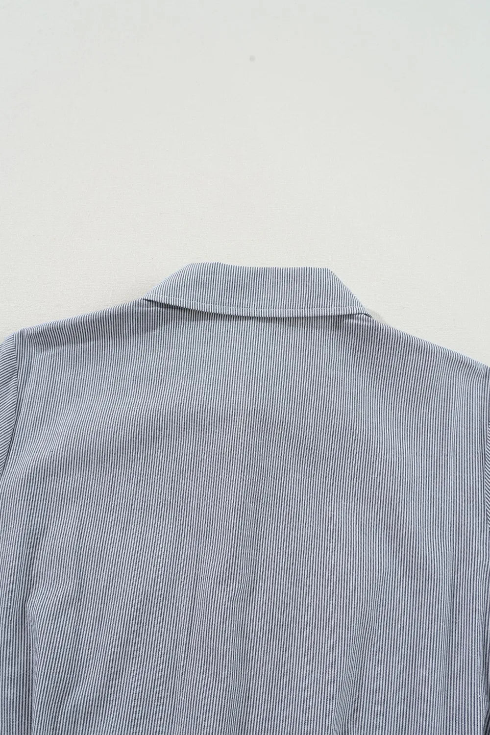 Romper, collared, short sleeve, cuff sleeve, buttoned, belted, opaque, pleated, elastic waist, no stretch close up view