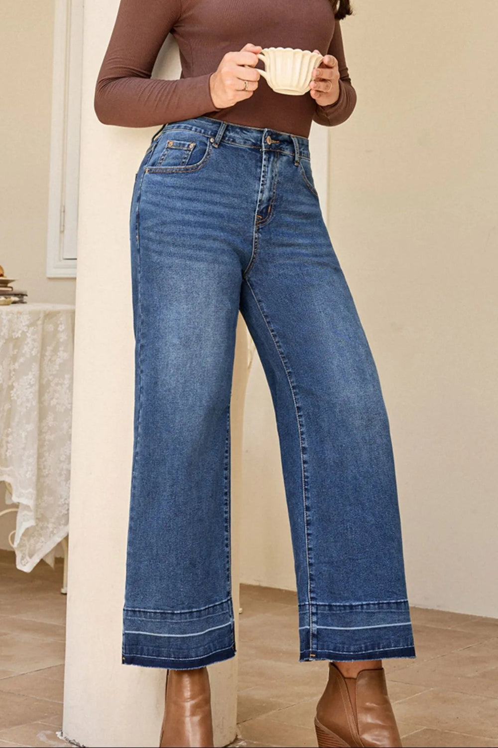 Jeans, high-rise, drop hem, raw hem, wide leg, pocketed, belt loops, button/zipper closure, vintage wash, some stretch, front view