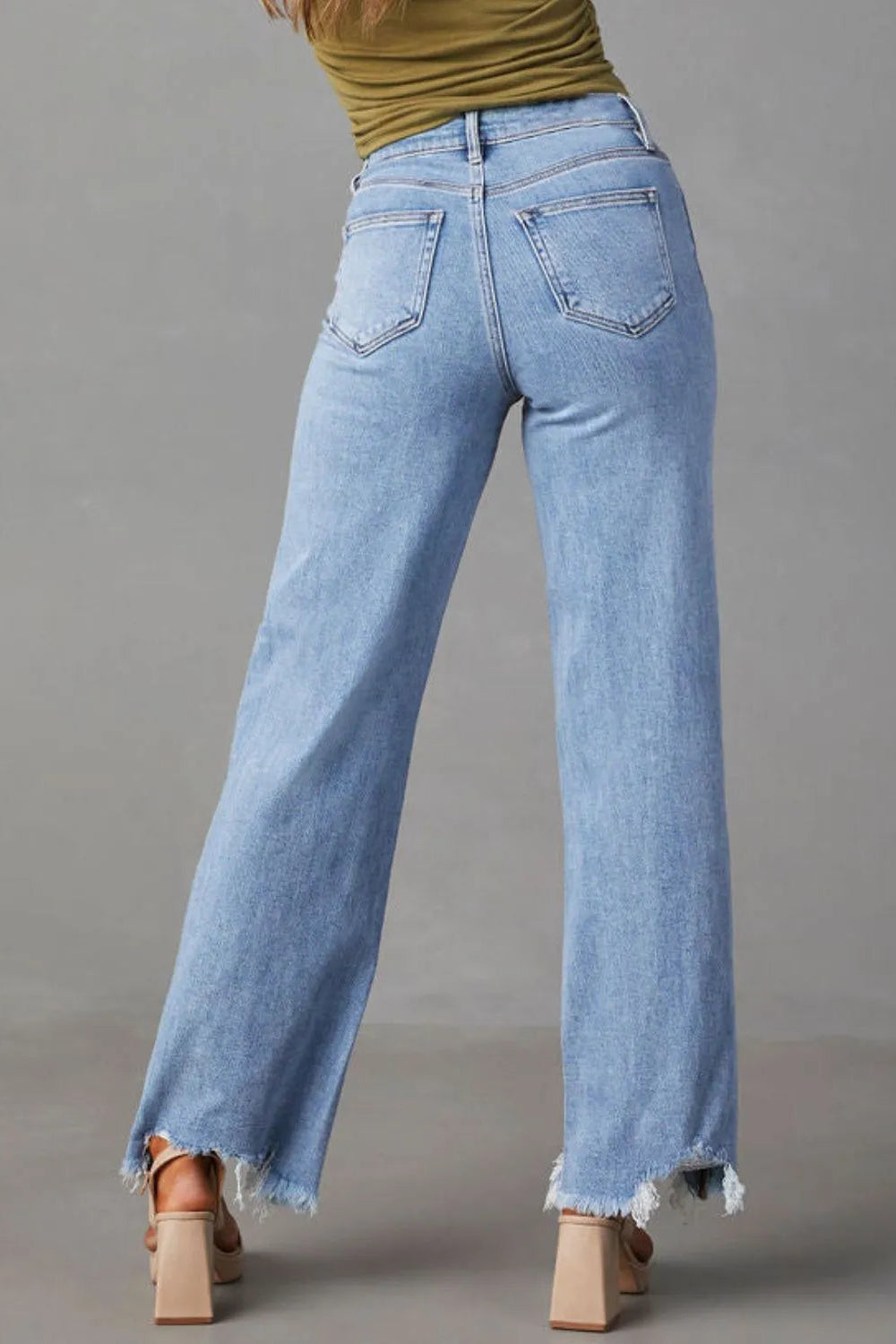 Jeans, high-waist, straight leg, 5 pocket design, light wash, raw hem, destroyed, button/zipper closure, belt loops, slightly stretchy, back view