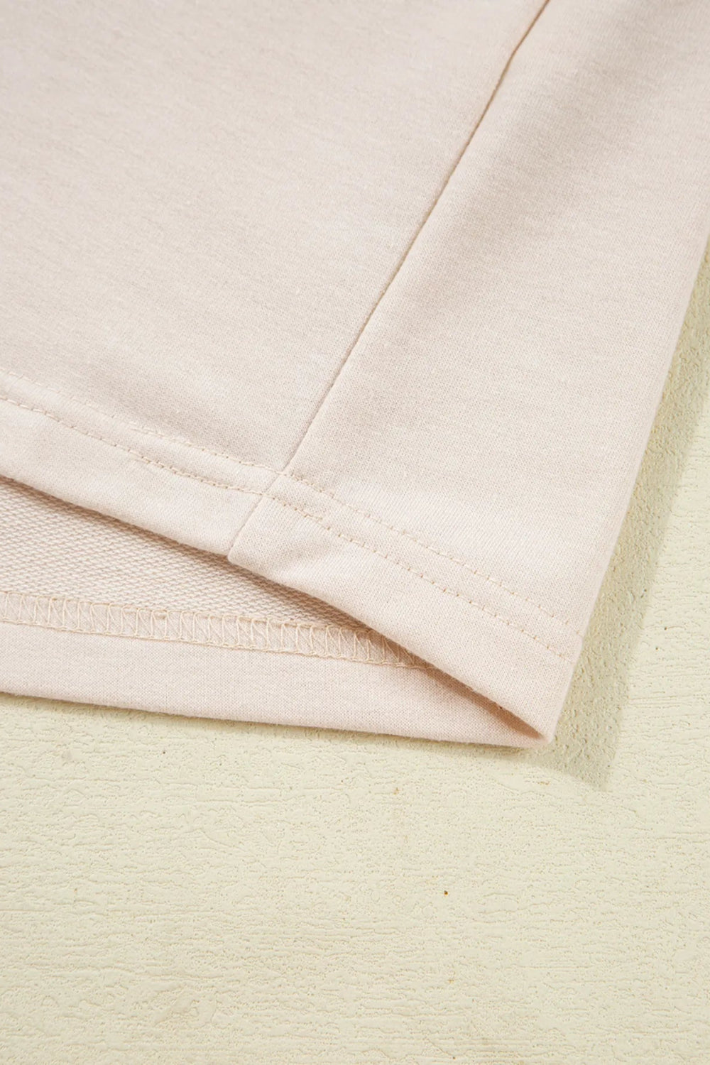 Top, henley, pullover, long sleeve, round neck, color block, waffle-knit, buttoned, slightly stretchy, close up view