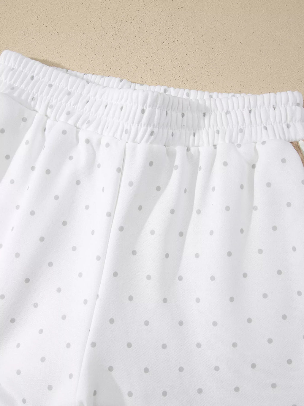 Cozy Dream Short Set in ivory with gray polka dots, a long-sleeve striped top, and matching ruffle-trim shorts close up view.