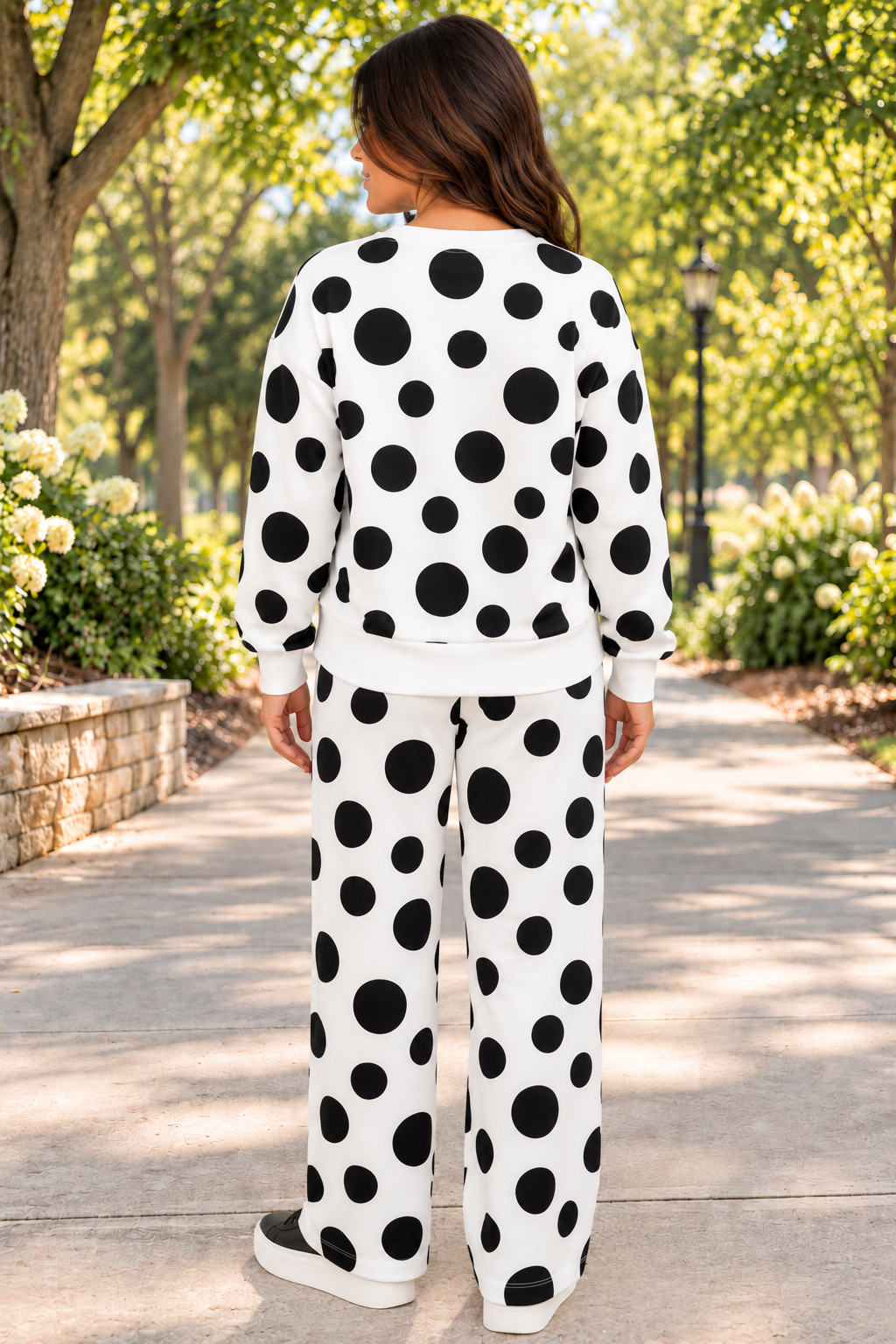Point Taken Pant Set In Black with an ivory-and-black polka-dot sweatshirt and matching wide-leg drawstring pants back view.