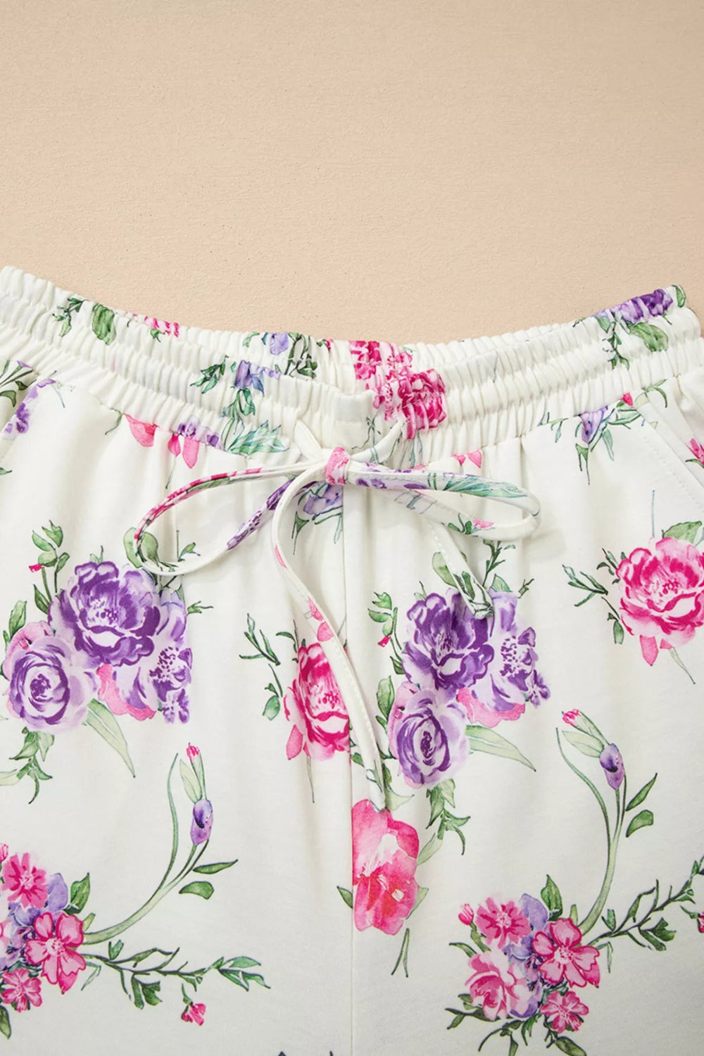 Two-piece loungewear set, floral print, round neck, long sleeves, drop shoulder, elastic waist, drawstring, pocketed, joggers, stretchy, close up view