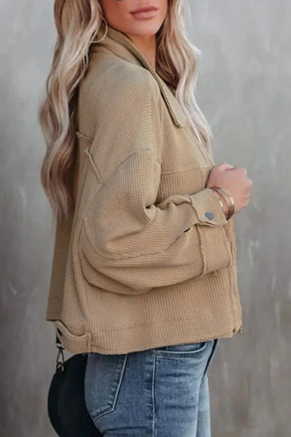 Jacket, collared, oversized, distressed, pleated, drop shoulder, buttoned, pocketed, long sleeve, waffle-knit, exposed seam, sits at the waist, pleated, adjustable straps, some stretch side view