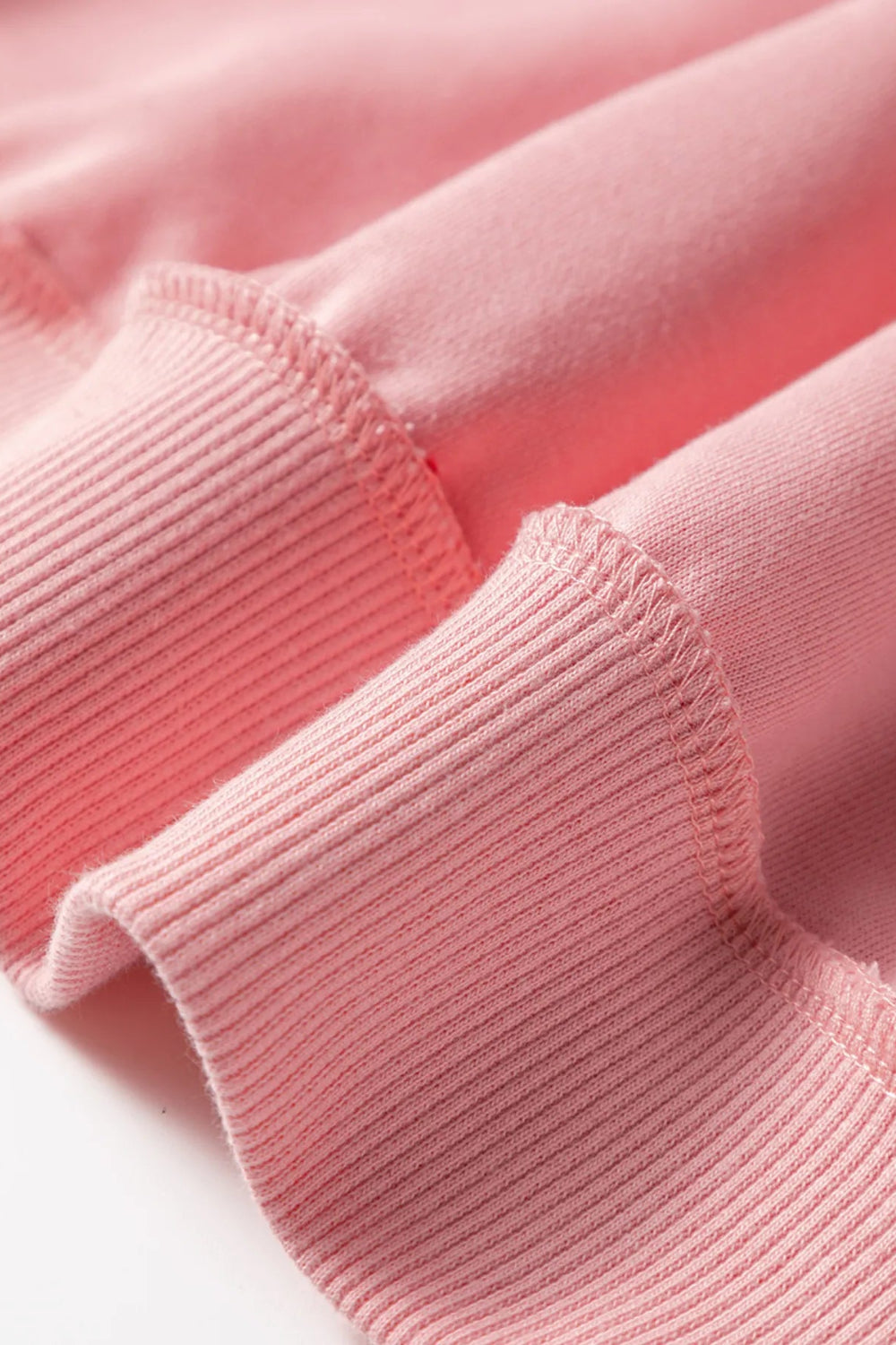 Top, mesh, patchwork, exposed seam, long sleeve, pullover, round neck, ribbed hem, slightly stretchy, close up view
