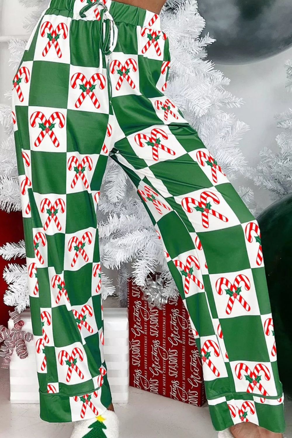 Pajama set, Two-piece, Collared, Long sleeve, Buttoned, Front patch pocket, contrast trim, Drawstring waist, pocketed bottoms, Candy cane/checkered print,
Slightly stretchy, close up bottom view