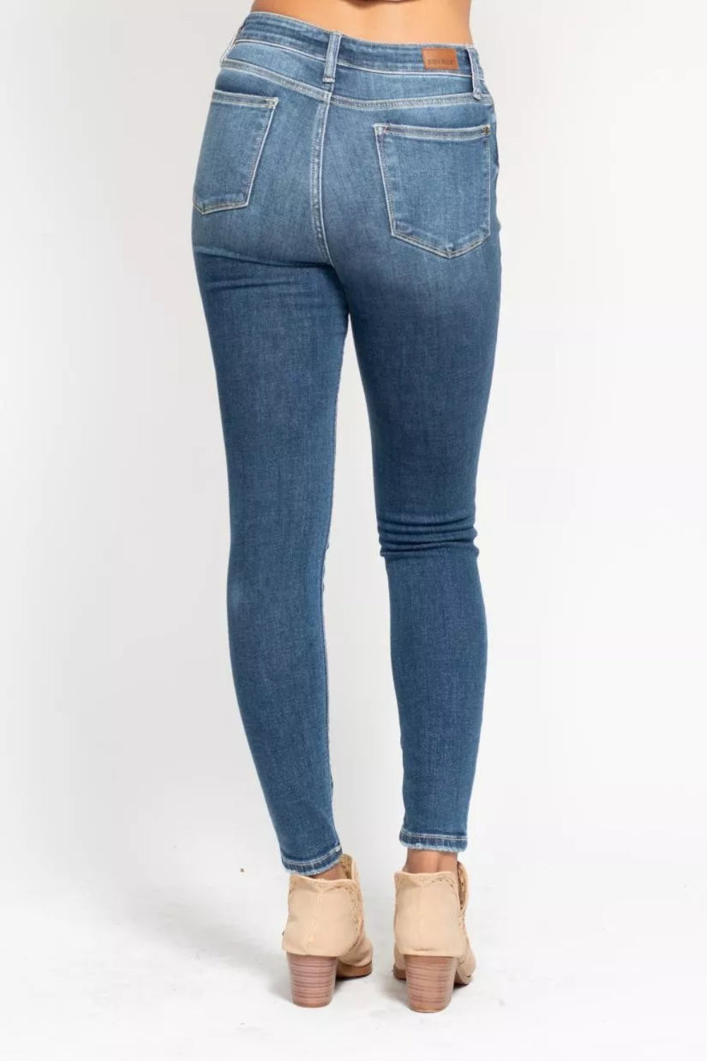 Judy Blue Jeans, full-size, high-rise, button fly, pocketed, belt loops, skinny leg, medium wash, slightly stretchy, back view