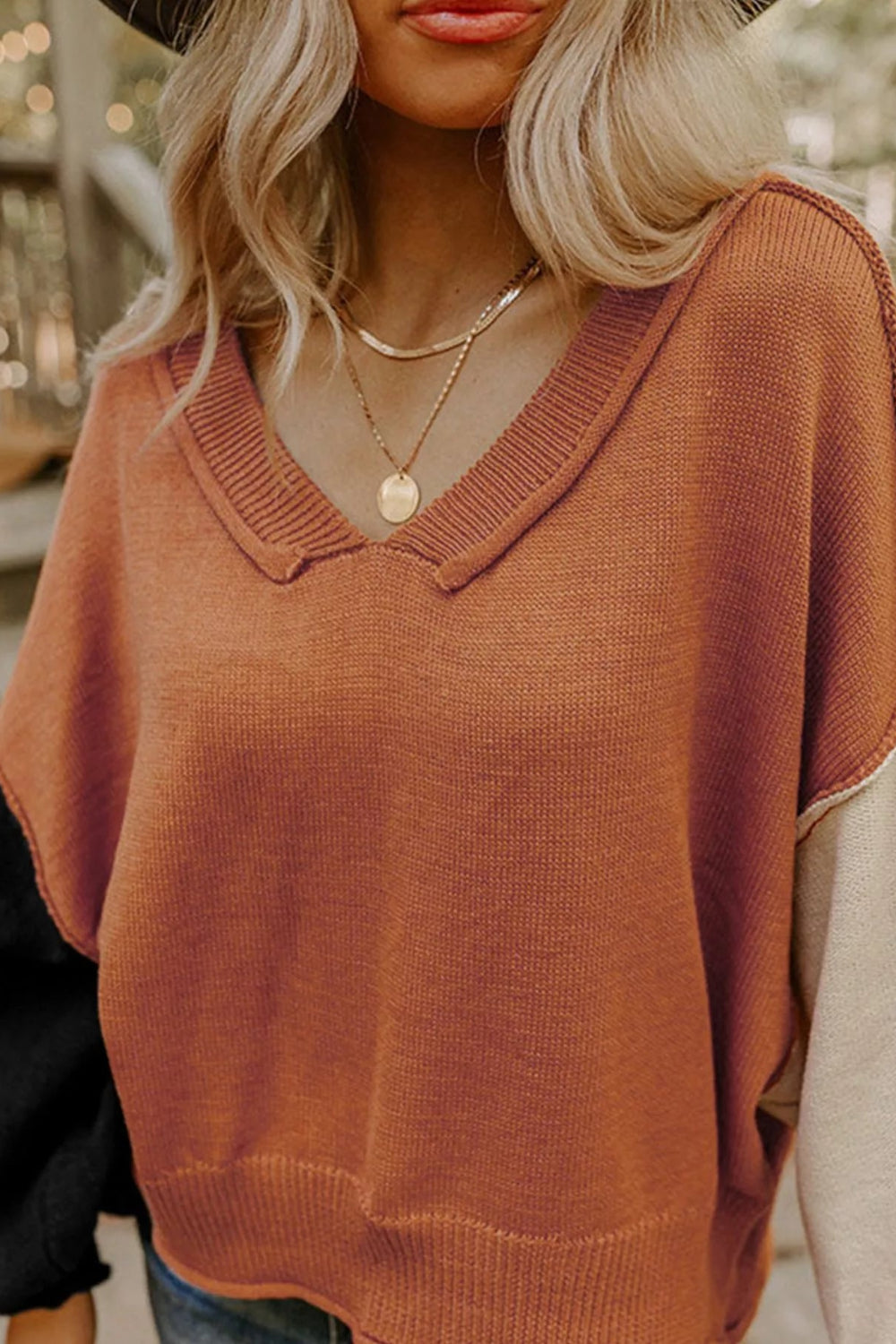 sweater, pullover, collared neck, long sleeve, drop shoulder, exposed seams, colorblock, balloon sleeves, ribbed collar, cuffs and hem, slightly stretchy, front view close up