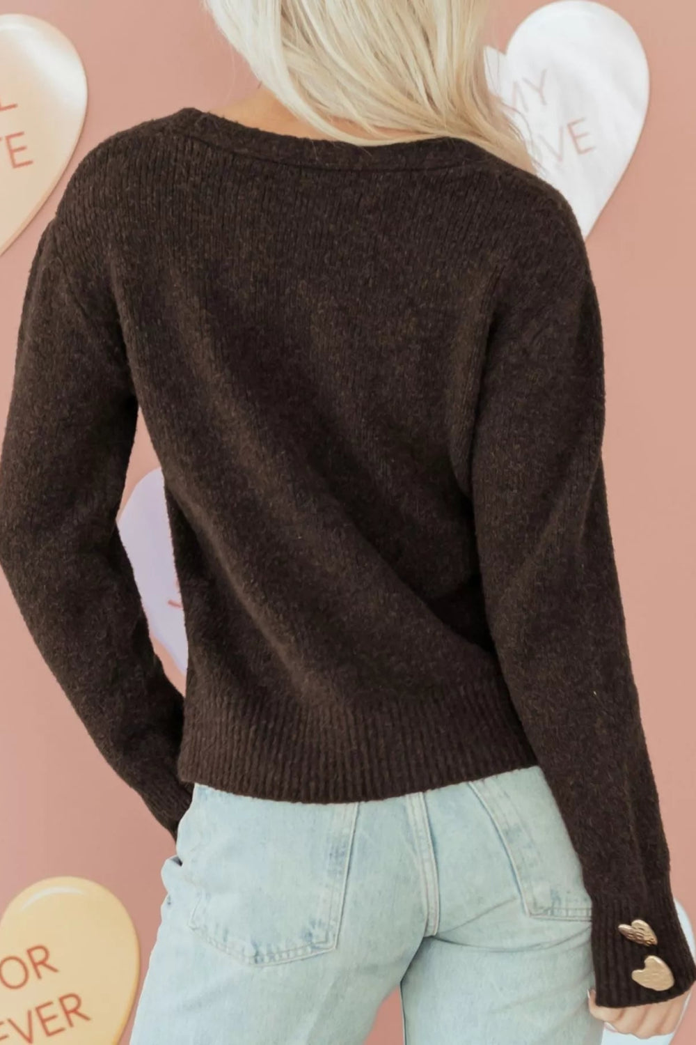 cardigan, chocolate color, long sleeve, v-neck, metal heart shaped button on front and cuffs, ribbed, medium length, slightly stretchy, back view