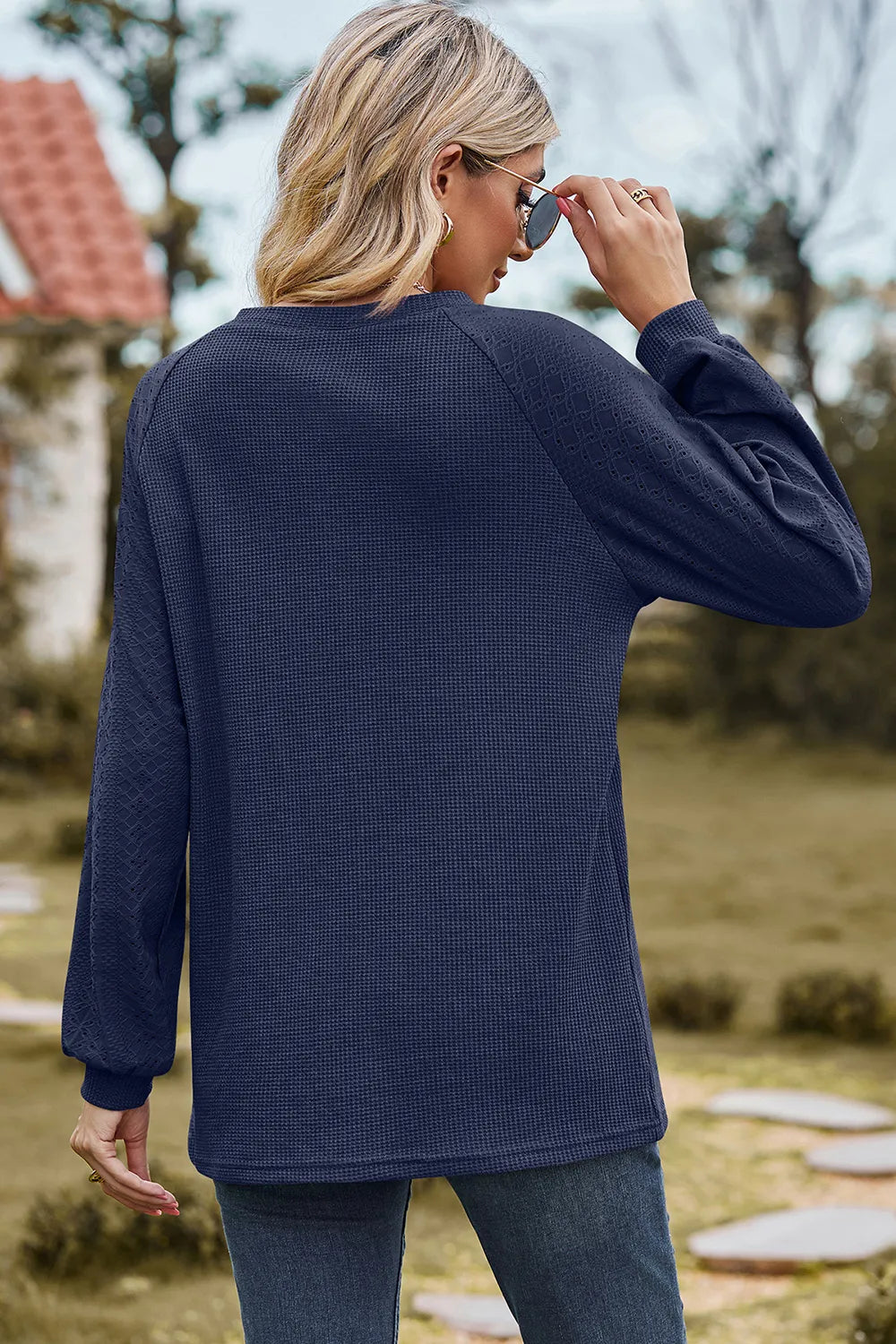 Top, raglan style, round neck, long sleeve, eyelet sleeves, ribbed, opaque, slightly stretchy, back view
