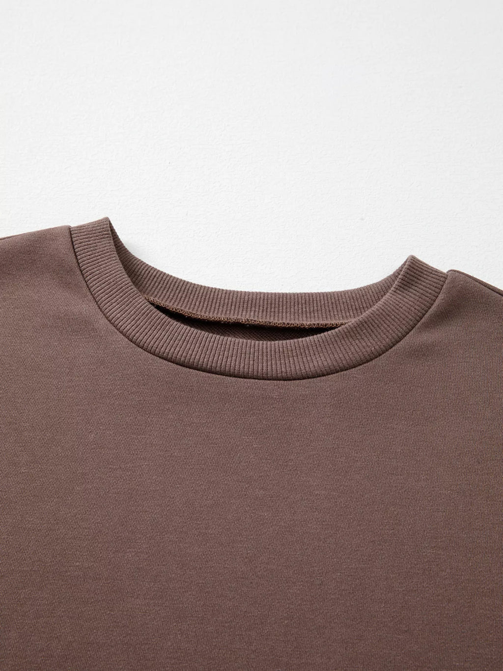 A Change Of Pace Sweatshirt in mocha brown with rust-orange and cream color-block sleeves, shown close up view.