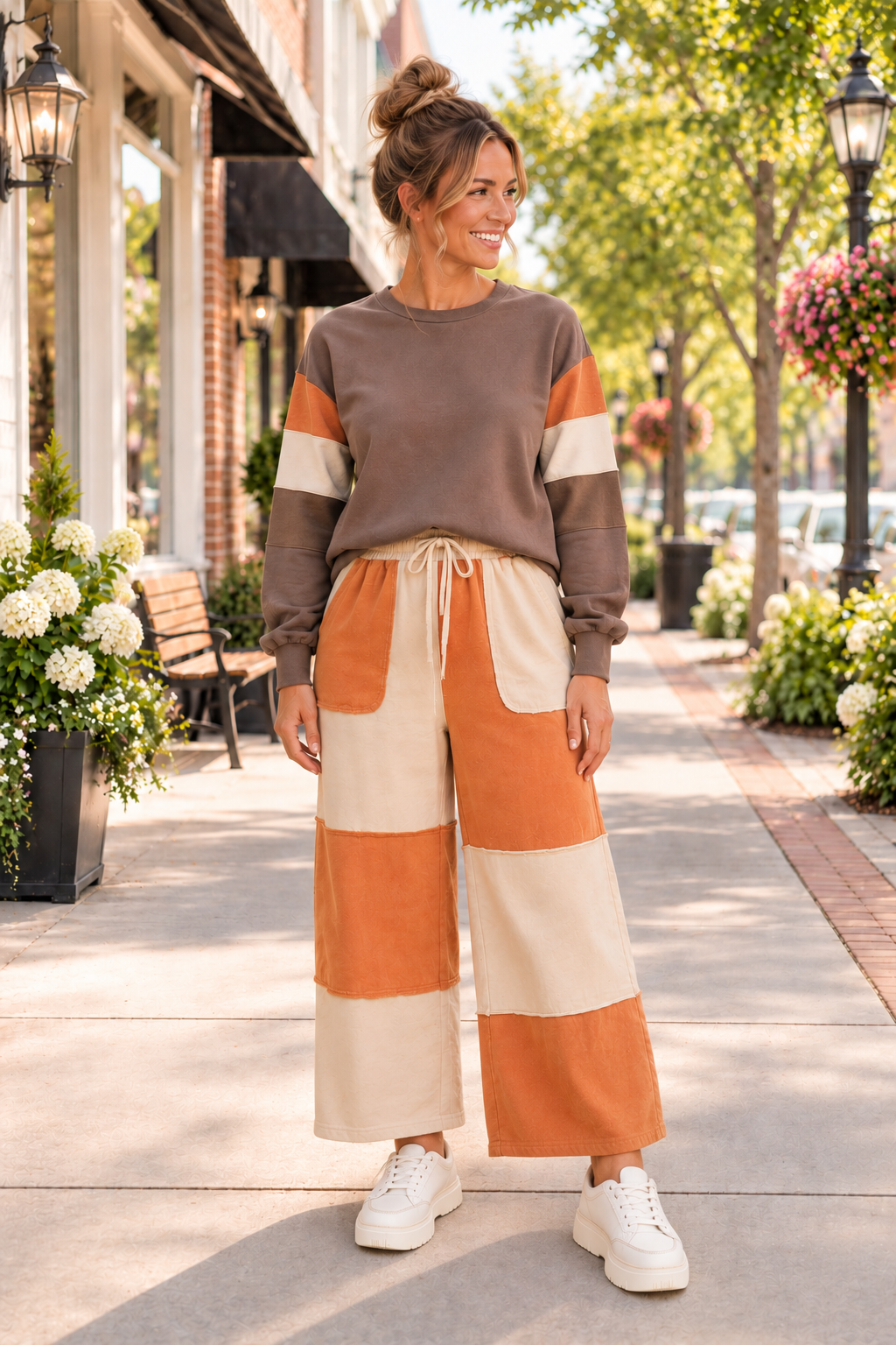 A woman wearing elastic high-waist, color block pants, with a drawstring, raw-seams, wide-leg with pockets, ankle length and slightly stretchy front view.