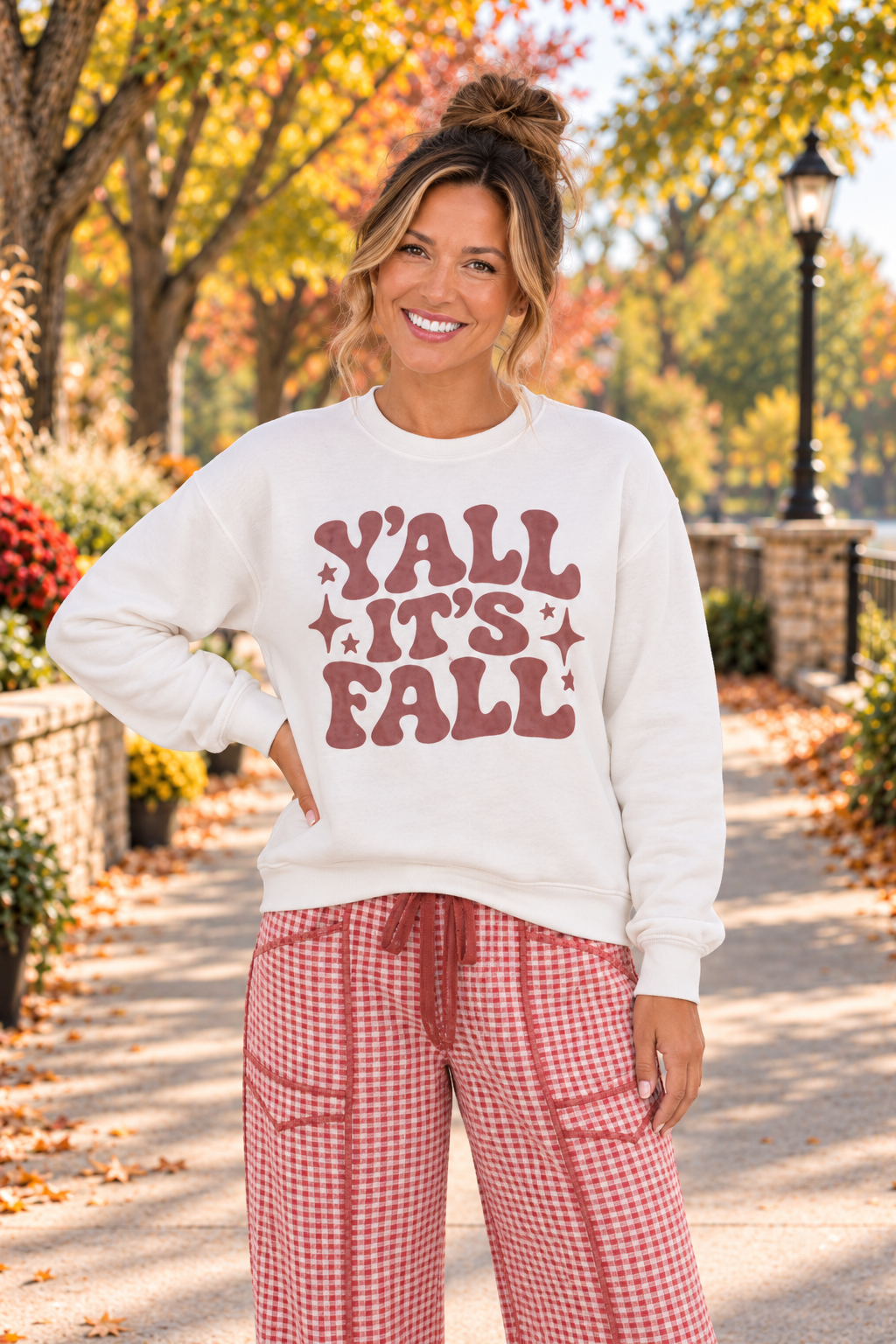 Y’all It’s Fall Graphic Sweatshirt in cream with muted red wavy lettering and star accents, shown from the front.