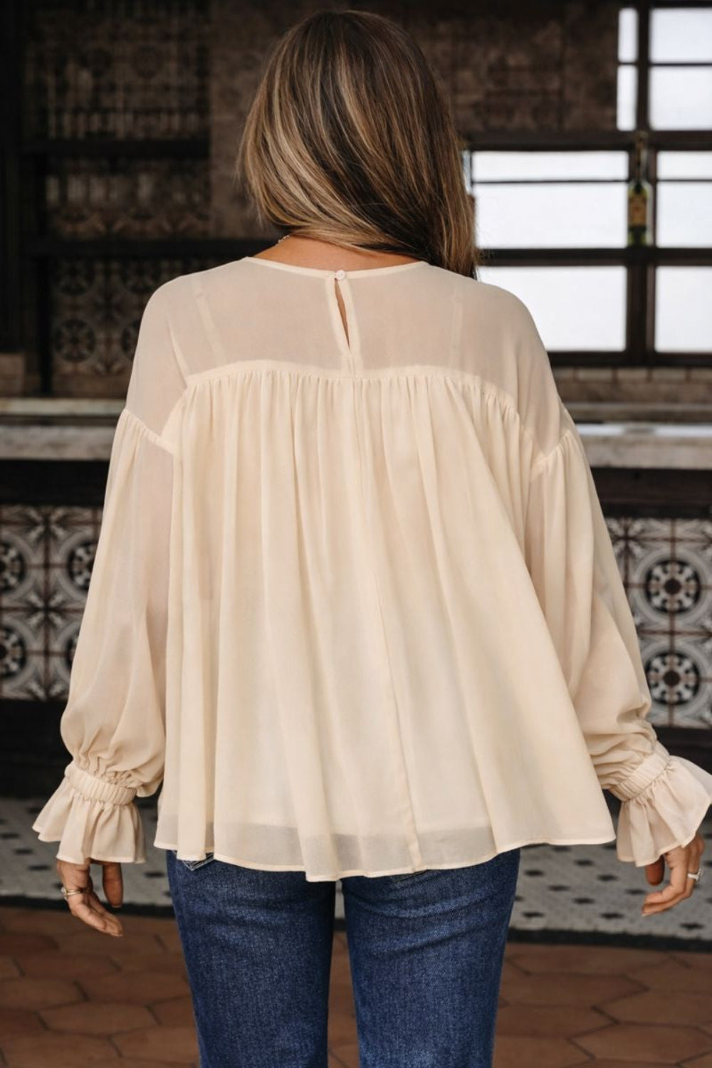 blouse, round neck, drop shoulder, long sleeve, ruffled, sheer arms and shoulders, lined, keyhole closure, oversized, no stretch, back view