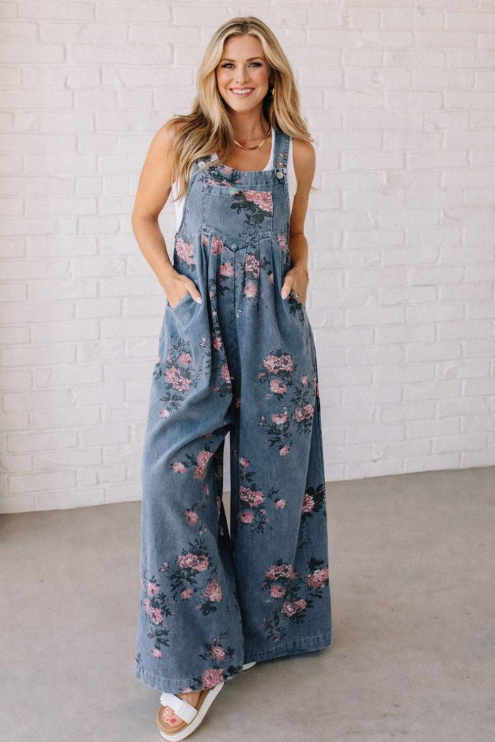 Overalls, floral print, wide leg, front bib pocket, front pockets, pleated, button straps, single back pocket, side button closure sit high, medium wash, slightly stretchy, front view