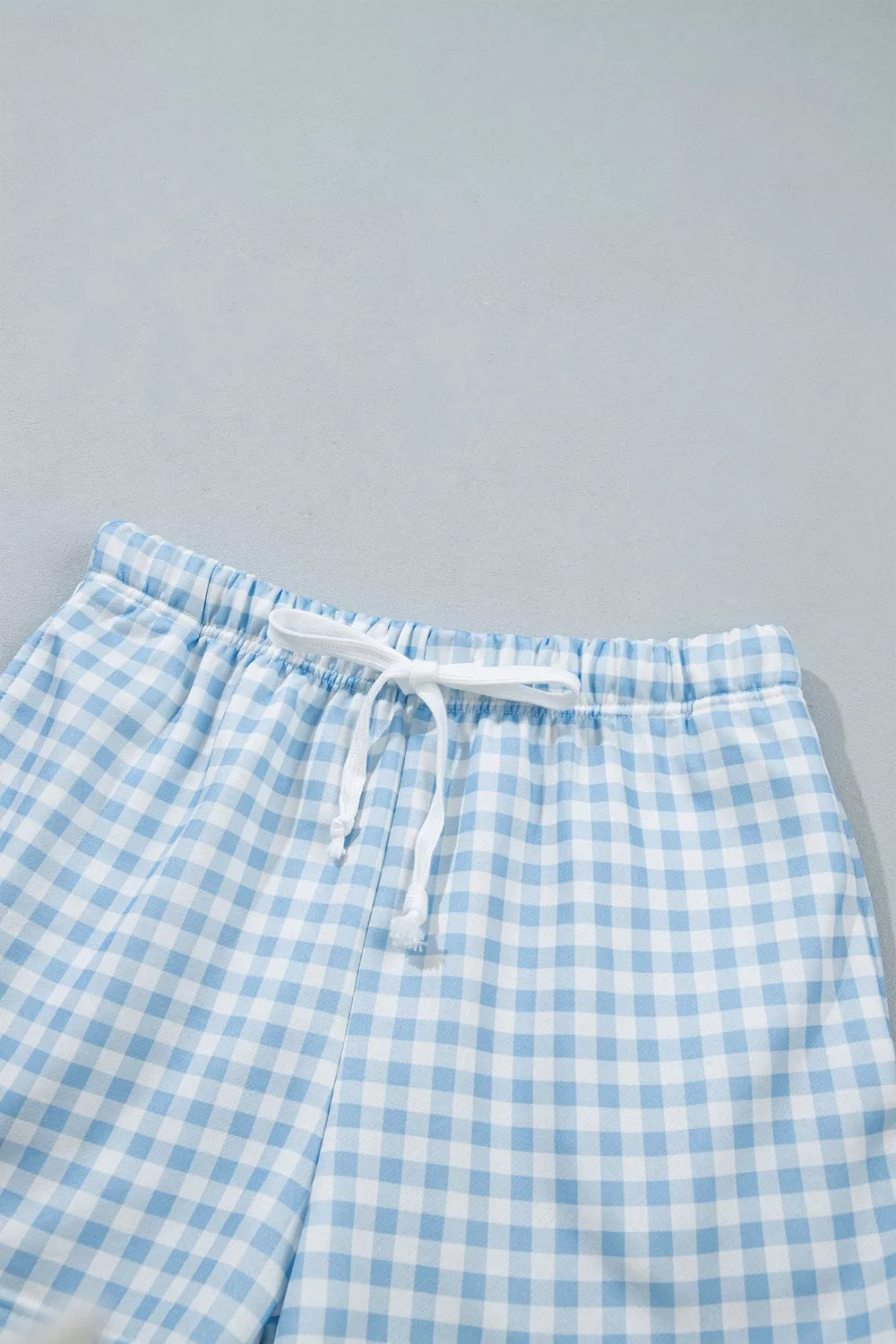 Since You Asked Short Set in light blue and white gingham with a long-sleeve top, white ribbed trim, and matching shorts.