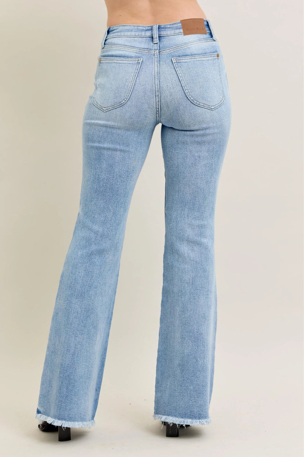 Judy Blue Jeans, full-size, high-rise, shield pocket, pocketed, flared, light wash, distressed knee, raw hem, stretchy, back view