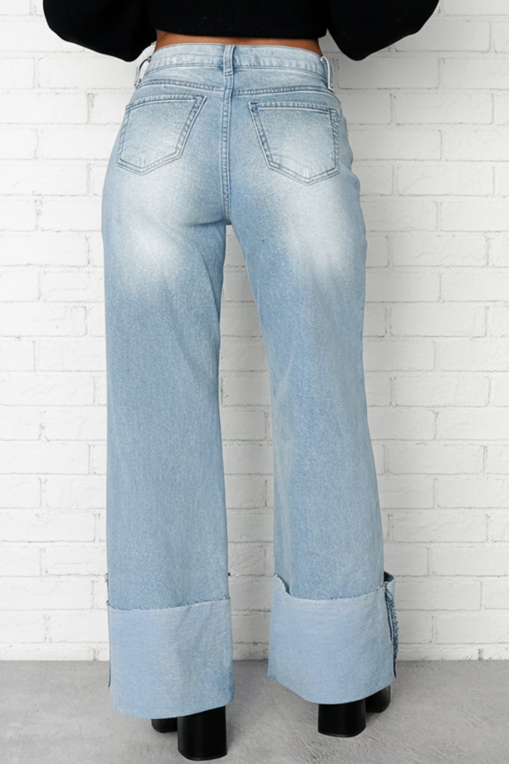 Jeans, high-waist, wide leg, high raw hem cuff, front patch pockets, light vintage wash, back pockets, belt loops, button/zipper closure, relaxed fit, slightly stretchy, back view
