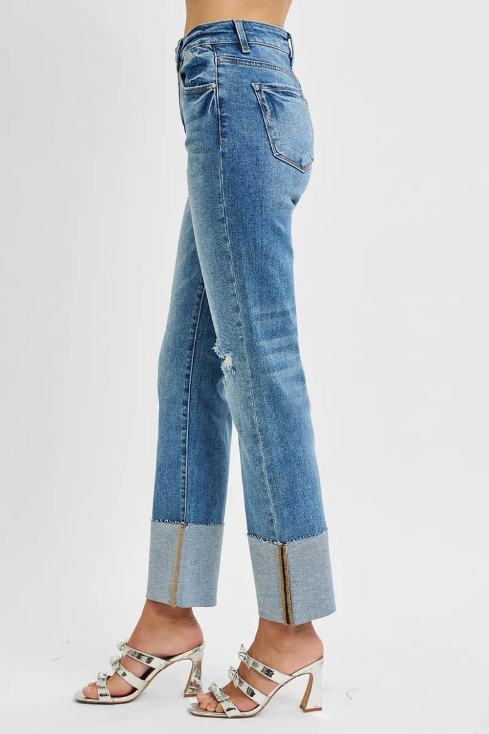 Risen jeans, full-size high-rise, wide cuffed, ankle length, straight leg, raw hem, distressed, vintage medium wash  5-pocket detail, button-zipper closure, belt looped, straight leg, ankle length, slightly stretchy, side view