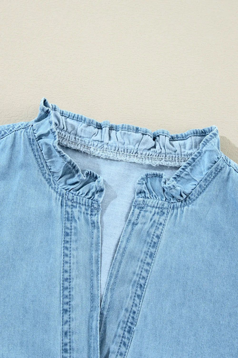 Denim mini dress, ruffled collar and shoulder, notched, long sleeve, button closure and cuff, pleated slightly front and back, no stretch close up view