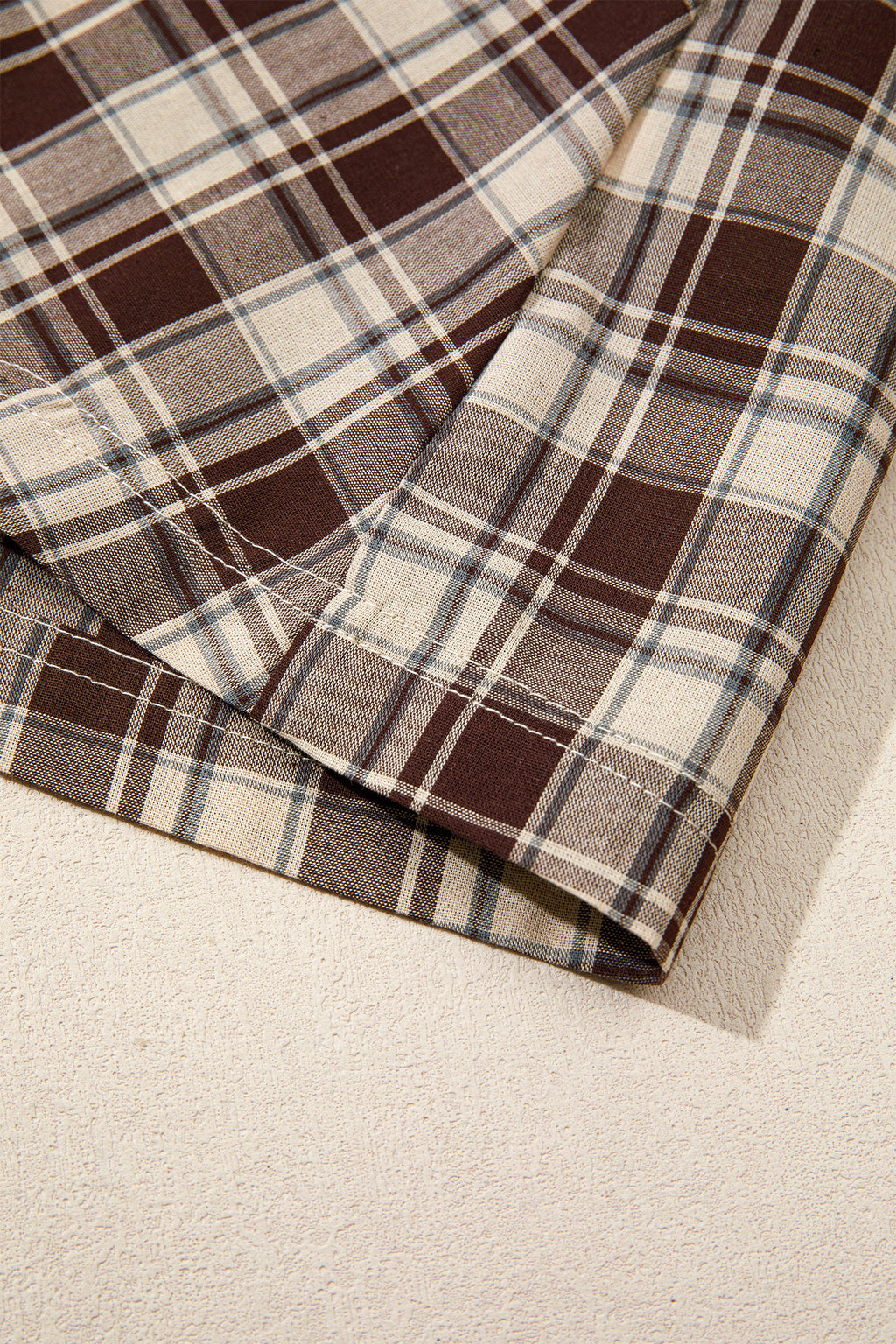 Front view of the Well Thought Of Mini Dress in brown and cream plaid with a collared button front, long sleeves, and pockets.